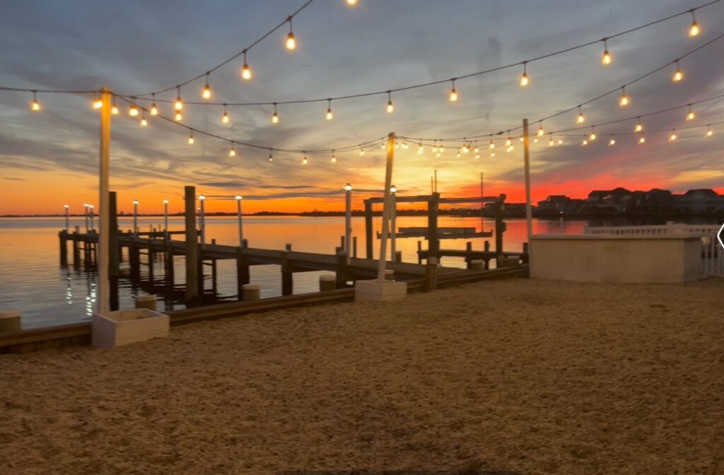 Sunset over the waterfront restaurant with docked boats in Tuckerton, NJ